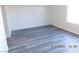 A bedroom showcasing modern gray vinyl flooring and fresh paint at 4382 Pinegrove St, Las Vegas, NV 89147