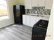 Bright kitchen featuring stainless steel appliances, white cabinets, modern backsplash, and light gray flooring at 4382 Pinegrove St, Las Vegas, NV 89147