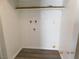Neat laundry room with plumbing hookups, white walls, and new laminate flooring; ready for appliances at 4382 Pinegrove St, Las Vegas, NV 89147