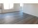 Bright living room featuring newly installed gray vinyl flooring, fresh paint, and natural light at 4382 Pinegrove St, Las Vegas, NV 89147
