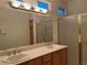 Bathroom boasts a double sink vanity with a large mirror and a glass shower at 5049 Alfingo St, Las Vegas, NV 89135