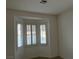 Bedroom features a bay window with shutters and carpet flooring at 5049 Alfingo St, Las Vegas, NV 89135