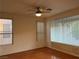 Bright bedroom with large windows, hardwood floors, and a ceiling fan at 5049 Alfingo St, Las Vegas, NV 89135