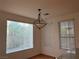 Cozy dining area features wood floors, a chandelier, and a window offering bright, natural light at 5049 Alfingo St, Las Vegas, NV 89135