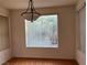 Well-lit dining area featuring hardwood floors and a charming chandelier at 5049 Alfingo St, Las Vegas, NV 89135