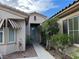 Inviting front entrance with decorative awning, mature landscaping, and well-maintained walkway at 5049 Alfingo St, Las Vegas, NV 89135