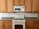Close up of the kitchen featuring a gas range, microwave, and ample cabinet space at 5049 Alfingo St, Las Vegas, NV 89135