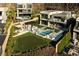 Aerial view of a luxury home's backyard featuring a pool, lounge, putting green, and outdoor dining at 523 Overlook Rim Dr, Henderson, NV 89012