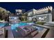 This backyard features a pool, outdoor seating, an outdoor kitchen, and artificial turf at 523 Overlook Rim Dr, Henderson, NV 89012