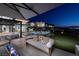 This backyard features multiple seating areas, a fire pit, and artificial turf at 523 Overlook Rim Dr, Henderson, NV 89012
