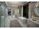 Contemporary bathroom with double vanities, soaking tub, and glass-enclosed shower, offering luxury and style at 523 Overlook Rim Dr, Henderson, NV 89012