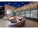 Relaxing outdoor patio with a cozy fire pit, comfortable seating, and ambient lighting, perfect for evening enjoyment at 523 Overlook Rim Dr, Henderson, NV 89012