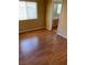Bedroom with hardwood floors, natural light from the window, and a view into the bathroom at 533 Via Santiago St, Las Vegas, NV 89144