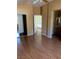 Bedroom featuring hardwood floors, closet with mirrored doors, and views to the hallway and bathroom at 533 Via Santiago St, Las Vegas, NV 89144