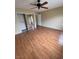 A bedroom with hardwood flooring, ceiling fan, mirrored closet and adjacent hall at 533 Via Santiago St, Las Vegas, NV 89144