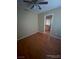 Bedroom with hardwood floors, neutral walls, ceiling fan, and ensuite bathroom at 533 Via Santiago St, Las Vegas, NV 89144