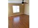 Bright bedroom featuring wood-look floors, natural light, and a ceiling fan at 533 Via Santiago St, Las Vegas, NV 89144