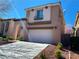 Inviting two-story home with a lush front yard and convenient two-car garage at 533 Via Santiago St, Las Vegas, NV 89144