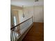 Bright foyer with hardwood floors and hanging light fixture from the second story at 533 Via Santiago St, Las Vegas, NV 89144