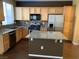 Updated kitchen with granite countertops, stainless steel appliances, wood cabinets, and a functional kitchen island at 533 Via Santiago St, Las Vegas, NV 89144