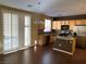 Well-lit kitchen featuring granite counters, modern appliances, wood cabinets, and sliding door access at 533 Via Santiago St, Las Vegas, NV 89144