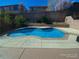 A refreshing backyard pool with a clean, modern design complemented by a concrete patio and lush landscaping at 533 Via Santiago St, Las Vegas, NV 89144