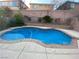 Inviting backyard pool featuring a unique shape, tiled border, and surrounding concrete patio at 533 Via Santiago St, Las Vegas, NV 89144