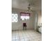 Bright dining area with tiled floors, a charming window display, and a classic ceiling fan at 5417 Seabaugh Ave, Las Vegas, NV 89107