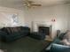 Cozy living room featuring a classic fireplace and plush seating beneath a ceiling fan at 5417 Seabaugh Ave, Las Vegas, NV 89107