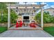 Outdoor living space with stylish pergola, fire pit, and a TV wall for entertainment at 5553 Coral Gate St, Las Vegas, NV 89148