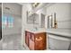 Modern bathroom featuring a wood vanity, sink, large mirror, and stylish marble floors at 5553 Coral Gate St, Las Vegas, NV 89148