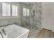 Bathroom showcasing modern tub and walk-in shower with tile surround at 5553 Coral Gate St, Las Vegas, NV 89148