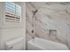 Bright bathroom with marble tiled walls, bathtub, shower and sleek design at 5553 Coral Gate St, Las Vegas, NV 89148