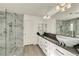 Modern bathroom with dual vanities, walk-in shower and door to the toilet at 5553 Coral Gate St, Las Vegas, NV 89148