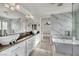 Bathroom featuring double sinks, walk-in shower, and modern tub at 5553 Coral Gate St, Las Vegas, NV 89148