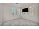 Bright bedroom with three windows, a wall-mounted TV, and gorgeous marble floors at 5553 Coral Gate St, Las Vegas, NV 89148