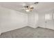 Bedroom features carpet, ceiling fan, and a calming neutral color palette at 5553 Coral Gate St, Las Vegas, NV 89148