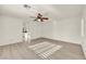 Bedroom features wood-look flooring, ceiling fan, and bright light at 5553 Coral Gate St, Las Vegas, NV 89148