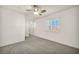 Bright bedroom features plush carpet, ceiling fan, and window with shutters at 5553 Coral Gate St, Las Vegas, NV 89148
