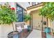 Charming entryway with a wrought iron gate, bench seating, and colorful potted rose bushes at 5553 Coral Gate St, Las Vegas, NV 89148