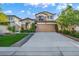 Charming home featuring a well-maintained lawn, mature trees, and a two-car garage at 5553 Coral Gate St, Las Vegas, NV 89148