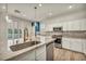 Updated kitchen with stainless steel appliances, an island, and hardwood flooring at 5553 Coral Gate St, Las Vegas, NV 89148