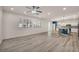 Well-lit living room with hardwood floors leading into a modern kitchen at 5553 Coral Gate St, Las Vegas, NV 89148