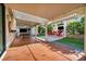 Covered outdoor patio featuring an outdoor kitchen, TV, multiple seating and dining areas at 5553 Coral Gate St, Las Vegas, NV 89148