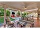 Covered patio with comfortable seating and a view of the backyard entertainment area at 5553 Coral Gate St, Las Vegas, NV 89148