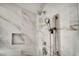 Bathroom shower with marble tile surround, dual shower heads, and built-in niche at 5553 Coral Gate St, Las Vegas, NV 89148