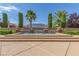 Beautiful backyard pool with water feature, surrounded by mature trees and a well-maintained landscape at 5576 Buena Martina Way, Las Vegas, NV 89141