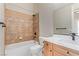 Well-lit bathroom featuring a tiled shower, modern vanity, and elegant fixtures at 5576 Buena Martina Way, Las Vegas, NV 89141