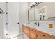 Bathroom featuring warm-toned vanity, marble countertop, black hardware, and white shaker-style doors at 5576 Buena Martina Way, Las Vegas, NV 89141