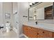 Bathroom featuring a shower, toilet, and marble-topped vanity with shaker cabinets and modern black hardware at 5576 Buena Martina Way, Las Vegas, NV 89141